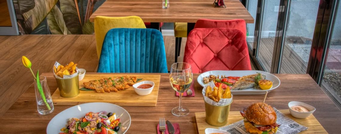 Colorful dining setup in a modern restaurant featuring diverse meals and vivid decor.